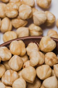 close-up-bowl-near-spilled-hazelnuts